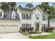 Charming two-story home with a well-manicured lawn and attached two-car garage at 104 Odessa Cir, Cary, NC 27513