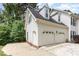 Spacious three car garage of home with white exterior and ample parking space at 104 Odessa Cir, Cary, NC 27513