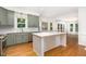 Well-lit kitchen featuring a marble island, stainless steel appliances and green cabinetry at 104 Odessa Cir, Cary, NC 27513