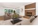 Comfortable living room with a brick fireplace, neutral furniture, and a sliding door to patio at 104 Odessa Cir, Cary, NC 27513