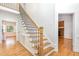 Elegant staircase with wood treads, white risers, and iron balusters providing a classic look at 104 Odessa Cir, Cary, NC 27513