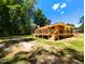 Expansive backyard featuring a brick house with a large wooden deck perfect for entertaining outdoors at 106 N Lakeside Dr, Smithfield, NC 27577