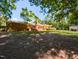 Large backyard showing the brick house, wooden deck, storage shed, and mature tree coverage at 106 N Lakeside Dr, Smithfield, NC 27577