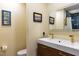 Bright bathroom featuring a double sink vanity with gold fixtures and a glass-enclosed shower at 106 N Lakeside Dr, Smithfield, NC 27577