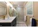 Bright bathroom featuring a double sink vanity with gold fixtures, patterned floors and a glass shower at 106 N Lakeside Dr, Smithfield, NC 27577