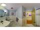 Bright bathroom with vanity sink, rounded mirror, and tile surround at 106 N Lakeside Dr, Smithfield, NC 27577