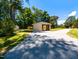 Long gravel driveway leading to a spacious shed, with backyard views at 106 N Lakeside Dr, Smithfield, NC 27577