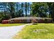 Brick home with tidy landscaping, set against a backdrop of mature trees and blue sky at 106 N Lakeside Dr, Smithfield, NC 27577