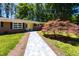 Close-up of brick home showing the landscaped entrance path and well-maintained lawn and landscaping at 106 N Lakeside Dr, Smithfield, NC 27577