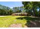Brick home featuring a well-kept lawn, mature trees and shrubs, set beneath a bright blue sky at 106 N Lakeside Dr, Smithfield, NC 27577