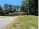 Charming brick home with a long driveway and well-maintained front yard, showcasing its curb appeal at 106 N Lakeside Dr, Smithfield, NC 27577