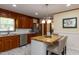 Modern kitchen with stainless steel appliances, wood cabinets, and island seating at 106 N Lakeside Dr, Smithfield, NC 27577