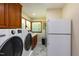 Bright laundry room with washer, dryer, ample counter space, and built-in cabinetry at 106 N Lakeside Dr, Smithfield, NC 27577