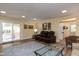 Inviting living room featuring a leather sofa, hardwood floors, and a sliding glass door to the deck at 106 N Lakeside Dr, Smithfield, NC 27577
