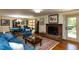 Comfortable living room featuring a fireplace and a dining area with ample natural light at 106 N Lakeside Dr, Smithfield, NC 27577