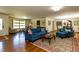 Spacious living room and dining area with blue sofa and hardwood floors at 106 N Lakeside Dr, Smithfield, NC 27577