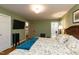 Main bedroom featuring a bed, ensuite bathroom, hardwood floors, and a TV at 106 N Lakeside Dr, Smithfield, NC 27577