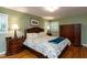 The main bedroom features a bed, hardwood floors, and a nightstand with lamp at 106 N Lakeside Dr, Smithfield, NC 27577