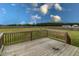 A spacious wooden back deck overlooks the expansive fenced-in backyard, offering outdoor living at 1071 Turlington Rd, Dunn, NC 28334