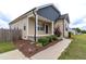 Beautiful exterior with landscaping, cozy front porch, and manicured greenery at 1071 Turlington Rd, Dunn, NC 28334