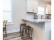 Kitchen counter with barstool seating and white cabinets at 1071 Turlington Rd, Dunn, NC 28334