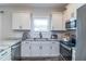 Modern kitchen featuring white cabinets, stainless steel appliances, and subway tile backsplash at 1071 Turlington Rd, Dunn, NC 28334
