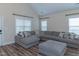 Bright living room with large sectional sofa, vaulted ceiling, and natural light at 1071 Turlington Rd, Dunn, NC 28334