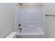 Standard shower tub with bronze fixtures and tiled walls at 1071 Turlington Rd, Dunn, NC 28334