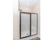 Clean shower with a black frame, sliding glass door, and white shower base with built in seat at 1071 Turlington Rd, Dunn, NC 28334