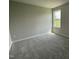A clean and simple bedroom design with plush carpeting and a bright window for natural light at 110 Coharie Dr, Lillington, NC 27546