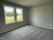 Carpeted bedroom featuring two windows providing lots of natural light at 110 Coharie Dr, Lillington, NC 27546