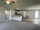 Open-concept kitchen and living area featuring new appliances and stylish wood-look flooring at 110 Coharie Dr, Lillington, NC 27546