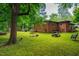 Spacious backyard with a brick home, patio area, and an open lawn at 112 Noble St, Chapel Hill, NC 27516