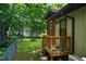 Backyard with deck, wooden fence, and abundant green trees at 112 Noble St, Chapel Hill, NC 27516