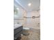 Tiled bathroom with shower-tub combo, modern vanity, and patterned floors at 112 Noble St, Chapel Hill, NC 27516
