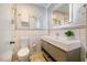 Stylish bathroom features a modern vanity with open shelving and a lighted mirror at 112 Noble St, Chapel Hill, NC 27516