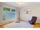 Relaxing bedroom featuring a large window and stylish chair on hardwood floors with rug at 112 Noble St, Chapel Hill, NC 27516