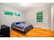 Bedroom featuring polished wood floors and three windows at 112 Noble St, Chapel Hill, NC 27516