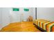 Sunlit bedroom features hardwood floors, and two windows filling the space with natural light at 112 Noble St, Chapel Hill, NC 27516