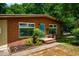 Charming brick home exterior with a bright blue front door and manicured landscaping at 112 Noble St, Chapel Hill, NC 27516