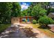 Charming single-story brick home with a vibrant blue front door and mature landscaping at 112 Noble St, Chapel Hill, NC 27516