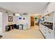 Bright, galley-style kitchen features ample counter space, white cabinets, and updated appliances at 112 Noble St, Chapel Hill, NC 27516