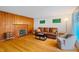 Inviting living room with a fireplace, wood paneling and hardwood floors at 112 Noble St, Chapel Hill, NC 27516