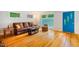 Living room boasts hardwood floors, a comfortable leather sofa, and natural light at 112 Noble St, Chapel Hill, NC 27516
