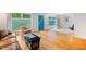 Bright living room featuring hardwood floors, a blue front door, and updated windows at 112 Noble St, Chapel Hill, NC 27516