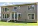 Backyard featuring an exterior elevation and well-maintained lawn at 113 Paladin Place, Cary, NC 27513