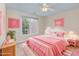 Bright bedroom featuring pink decor, natural light, and a ceiling fan at 113 Paladin Place, Cary, NC 27513