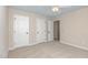 Neutral bedroom with white doors, plush carpeting, and a ceiling fan at 113 Paladin Place, Cary, NC 27513