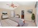 Airy bedroom with light carpet, modern furniture and door leading to updated bathroom at 113 Paladin Place, Cary, NC 27513