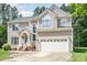 Inviting two-story home with well-maintained facade, attached two-car garage, and lush greenery at 113 Paladin Place, Cary, NC 27513